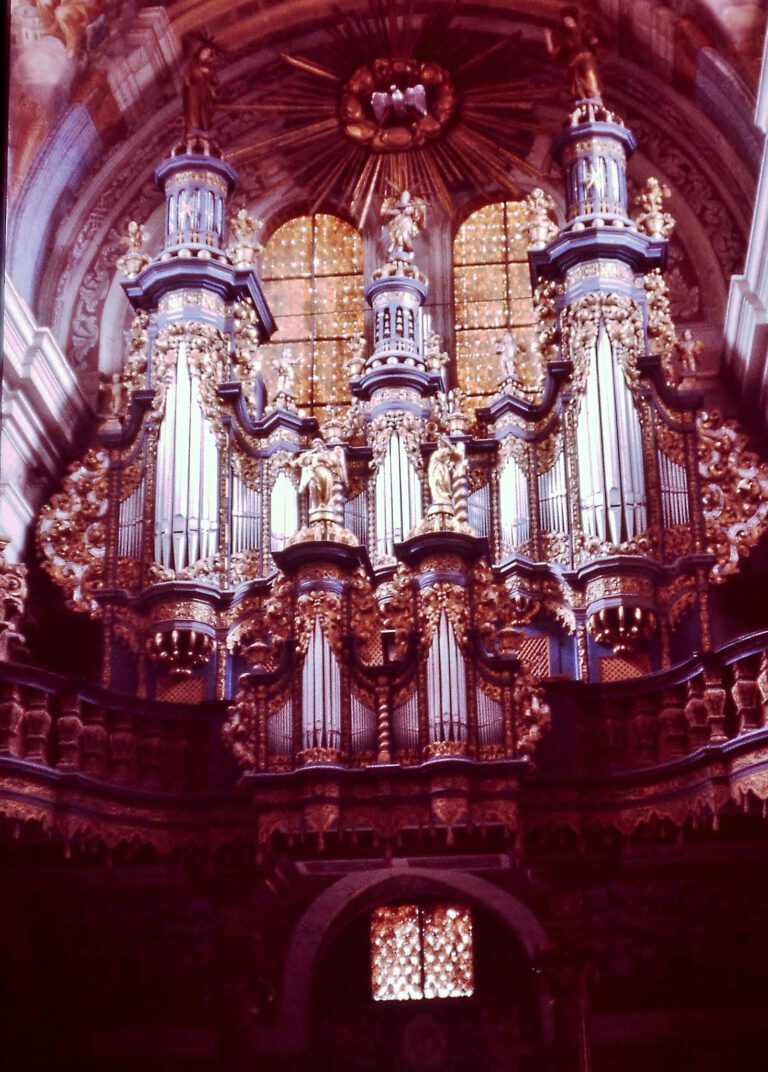 A stunningly ornate church organ with intricate gothic details in a Polish cathedral.